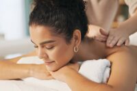 St Petersburg FL massage—therapist giving relaxing back massage in spa setting.