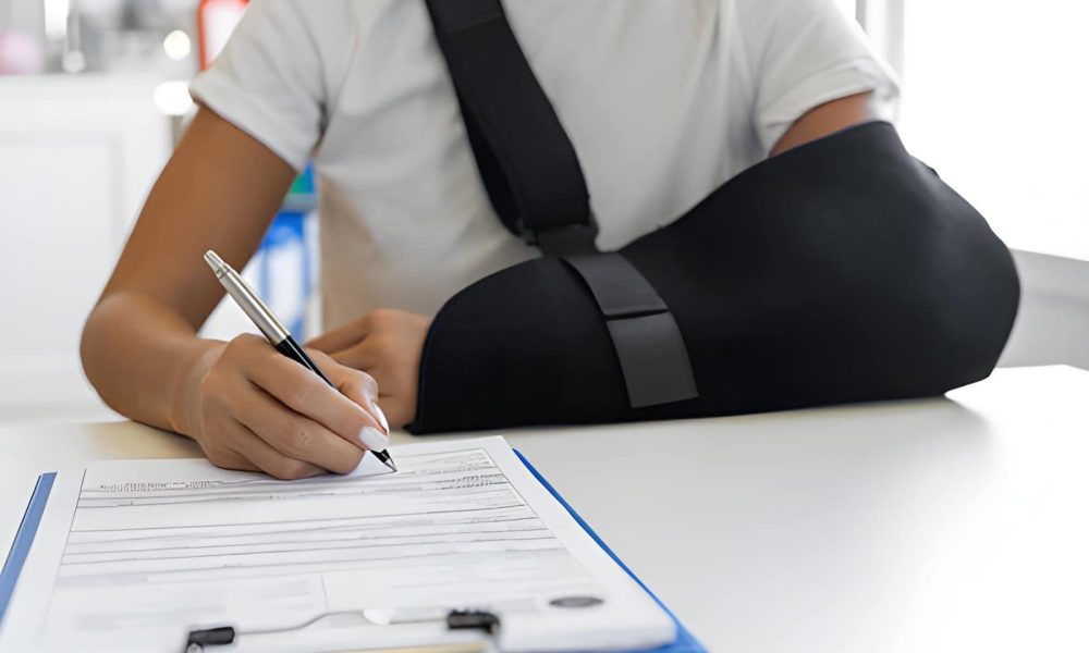 Auto Accident Chiropractor St Petersburg FL patient with arm sling completing medical form on clipboard.