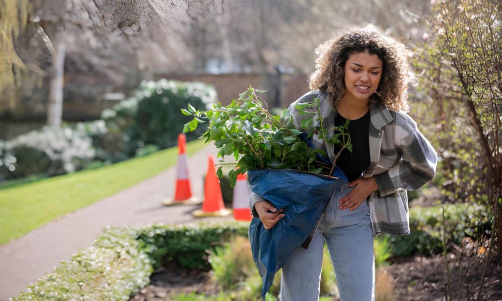 Pelvic floor dysfunction women physical therapists St Petersburg FL—woman carrying plants symbolizing growth and wellness.