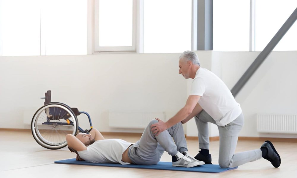 Physical Therapy Clinic in St. Petersburg therapist assisting patient with core exercise on mat.